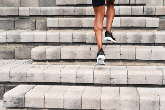 **Optimized Alt Text:** Man climbing outdoor stairs to raise heart rate into aerobic zone, showing how cardio effort is relative to fitness level – Imprüv