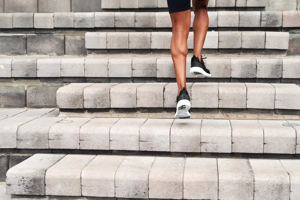 Man climbing outdoor stairs to raise heart rate into aerobic zone, showing how cardio effort is relative to fitness level – Imprüv