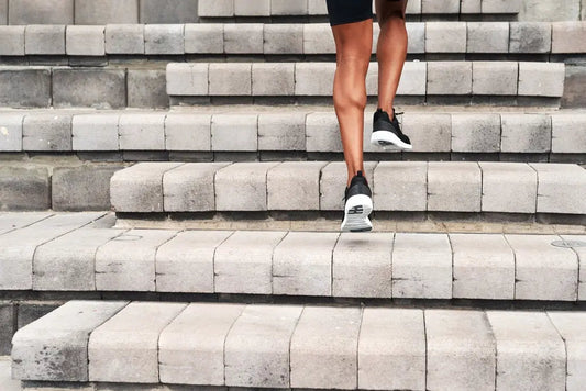 Man climbing outdoor stairs to raise heart rate into aerobic zone, showing how cardio effort is relative to fitness level – Imprüv