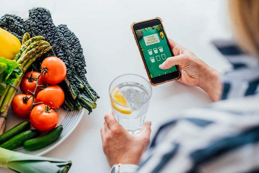 Tracking water intake as part of a consistent daily habit, showing how small actions drive long-term wellness and behavior change