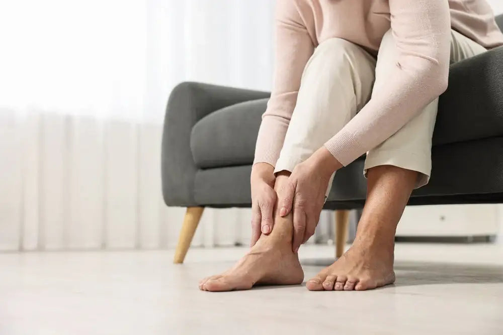 Woman holding her foot in discomfort, suggesting nerve pain or neuropathy—conditions Alpha Lipoic Acid may help relieve.